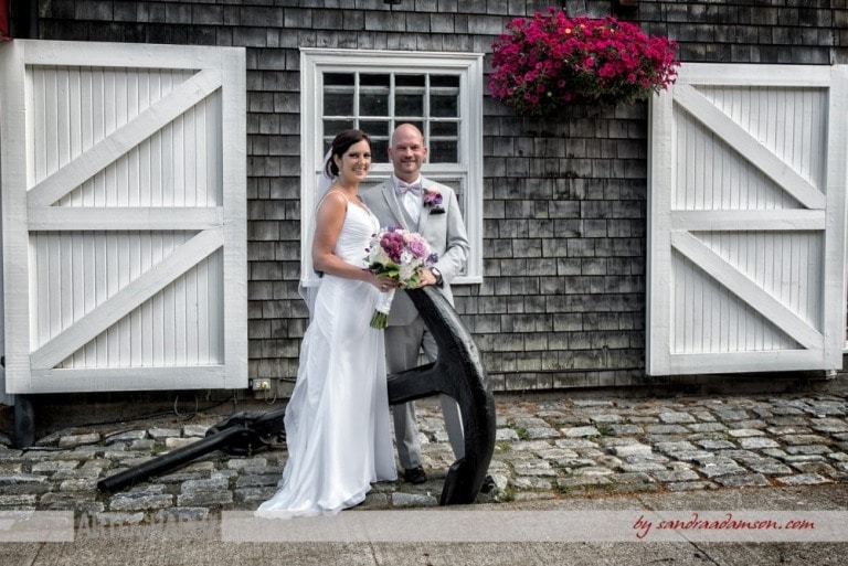 The bride and groom pose for wedding photos at the rustic Historic Properties in Halifax.