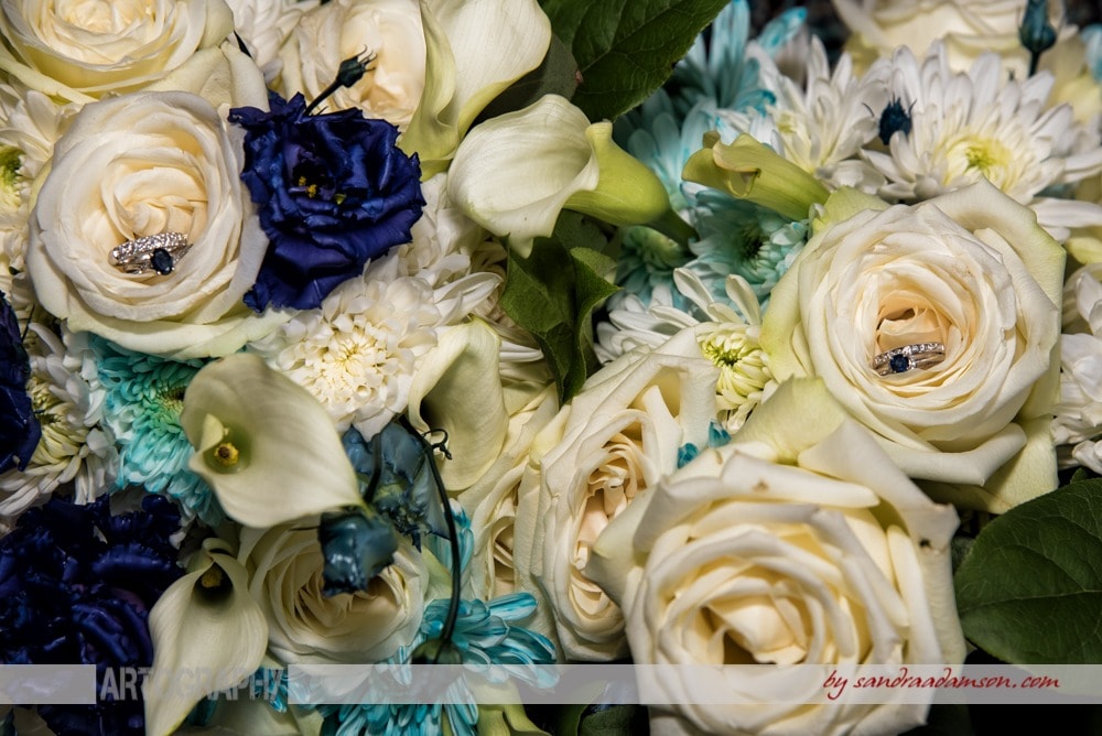 A gay wedding, ivory and navy bridal bouquet with sapphire wedding bands.