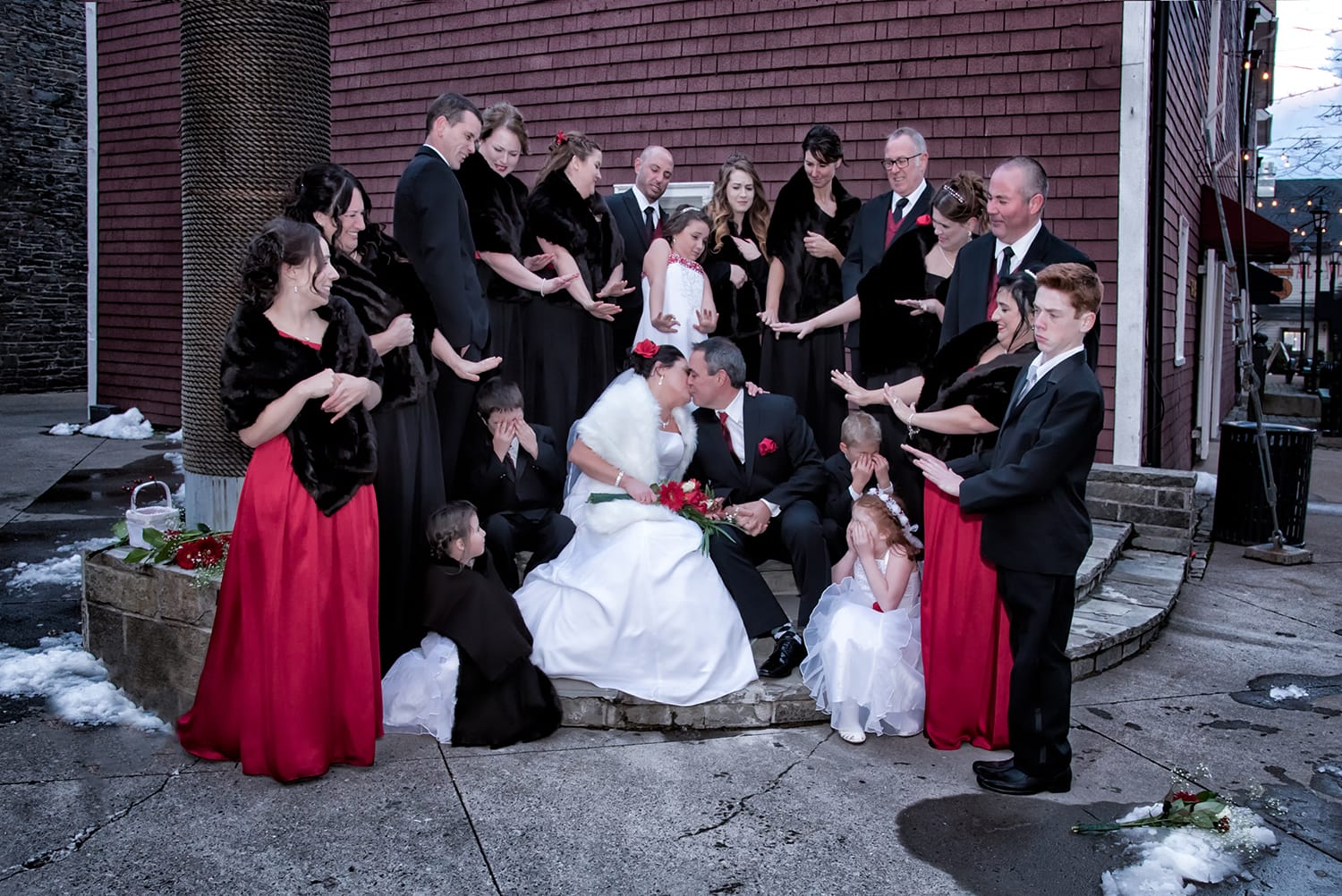 Funny wedding party photos with the bride and groom kissing at the Historic Properties captured by Halifax Nova Scotia wedding photographers Sandra Adamson Studios.