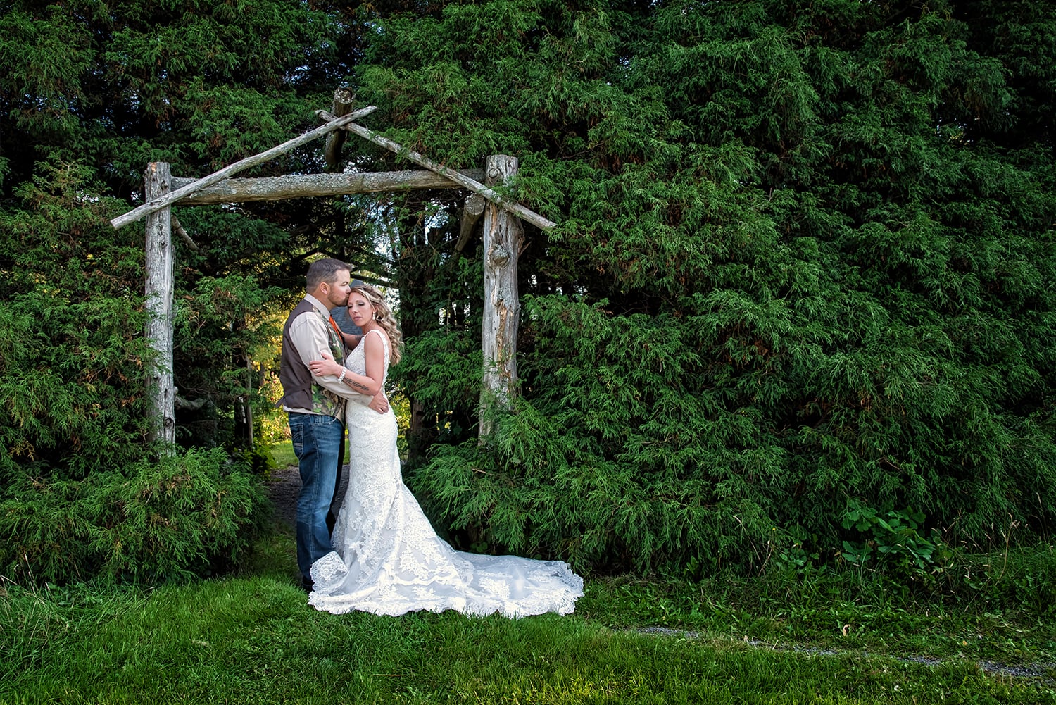 A bride and groom embrace each other during wedding photos at the Truro Rock Gardens.