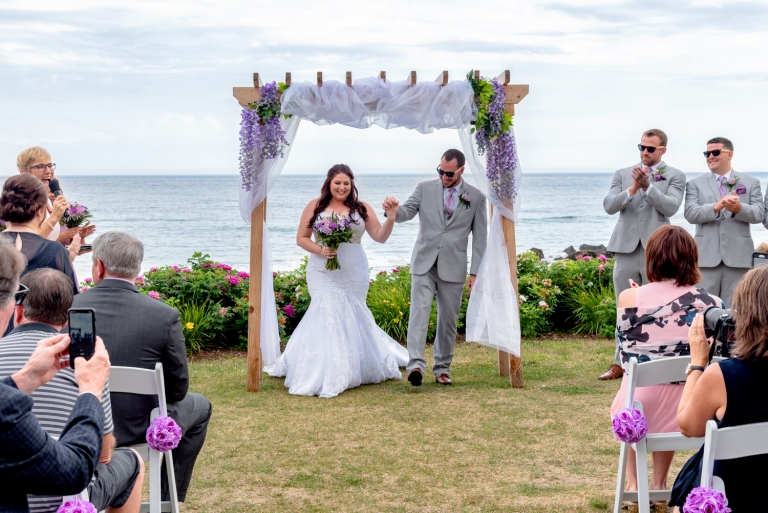 A bride and groom walk down the aisle after their wedding ceremony at White Point in NS.