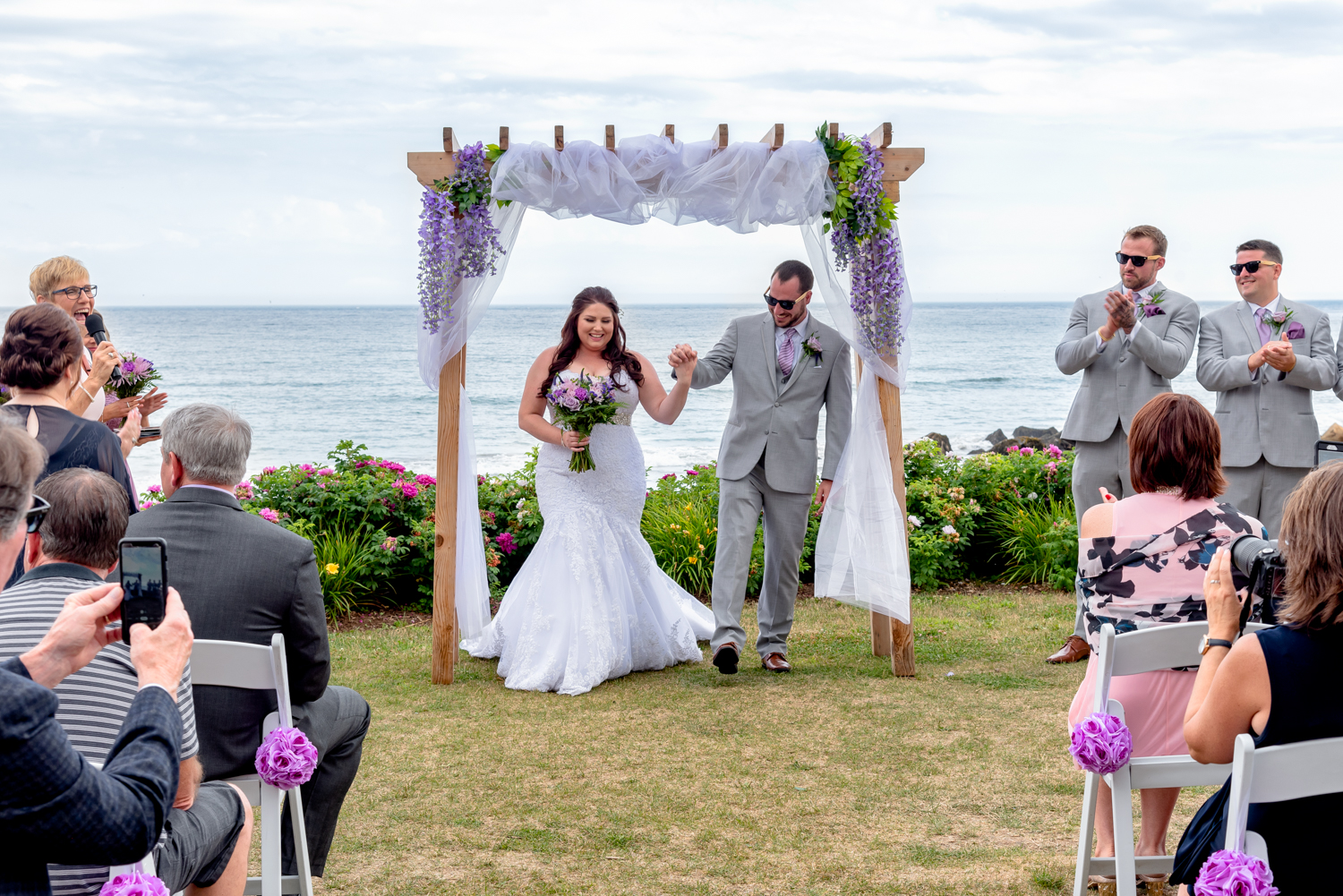 A bride and groom walk down the aisle after their ceremony wedding photography coverage at White Point in NS.