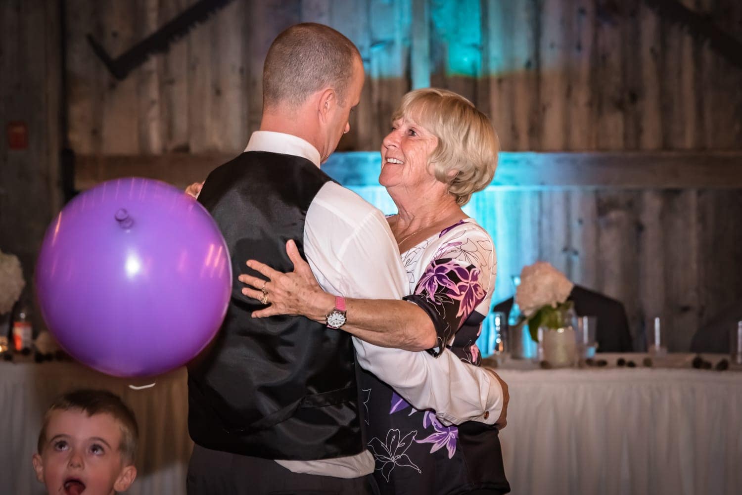 A mother dance's with her son, the groom, during his wedding at the Old Orchard Inn Heritage Barn in Wolfville NS.