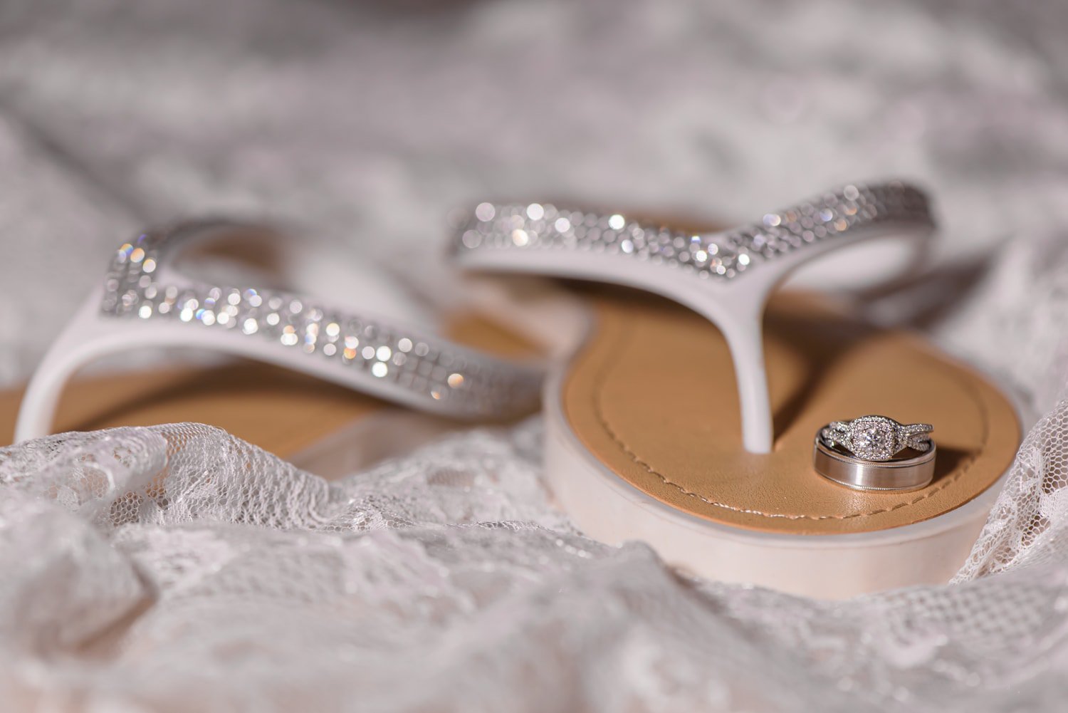 The bride's wedding shoes were sandals and their wedding rings.