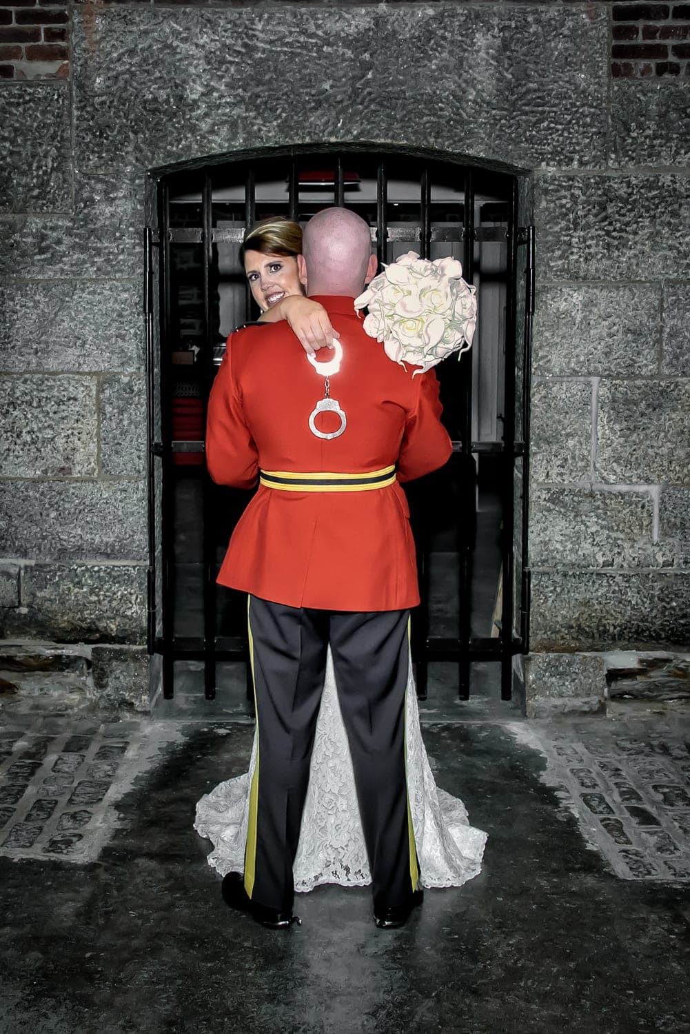Bride and groom with RCMP handcuffs wedding photos at Alexander Keiths Brewery in Halifax.
