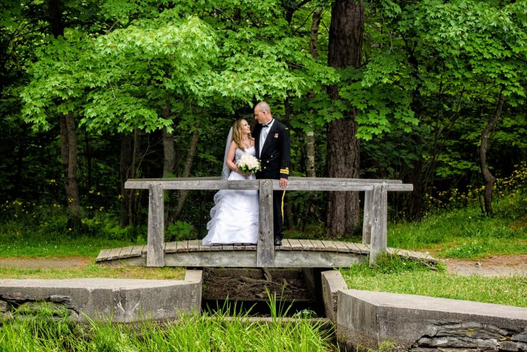 Wedding photos of bride and groom on a wooden bridge in point pleasant park Halifax.