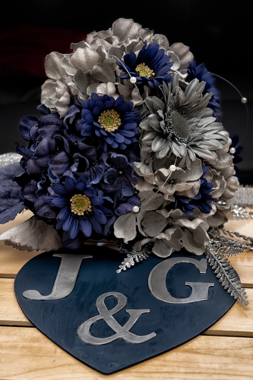 A silk faux flower bridal bouquet in navy and grey.
