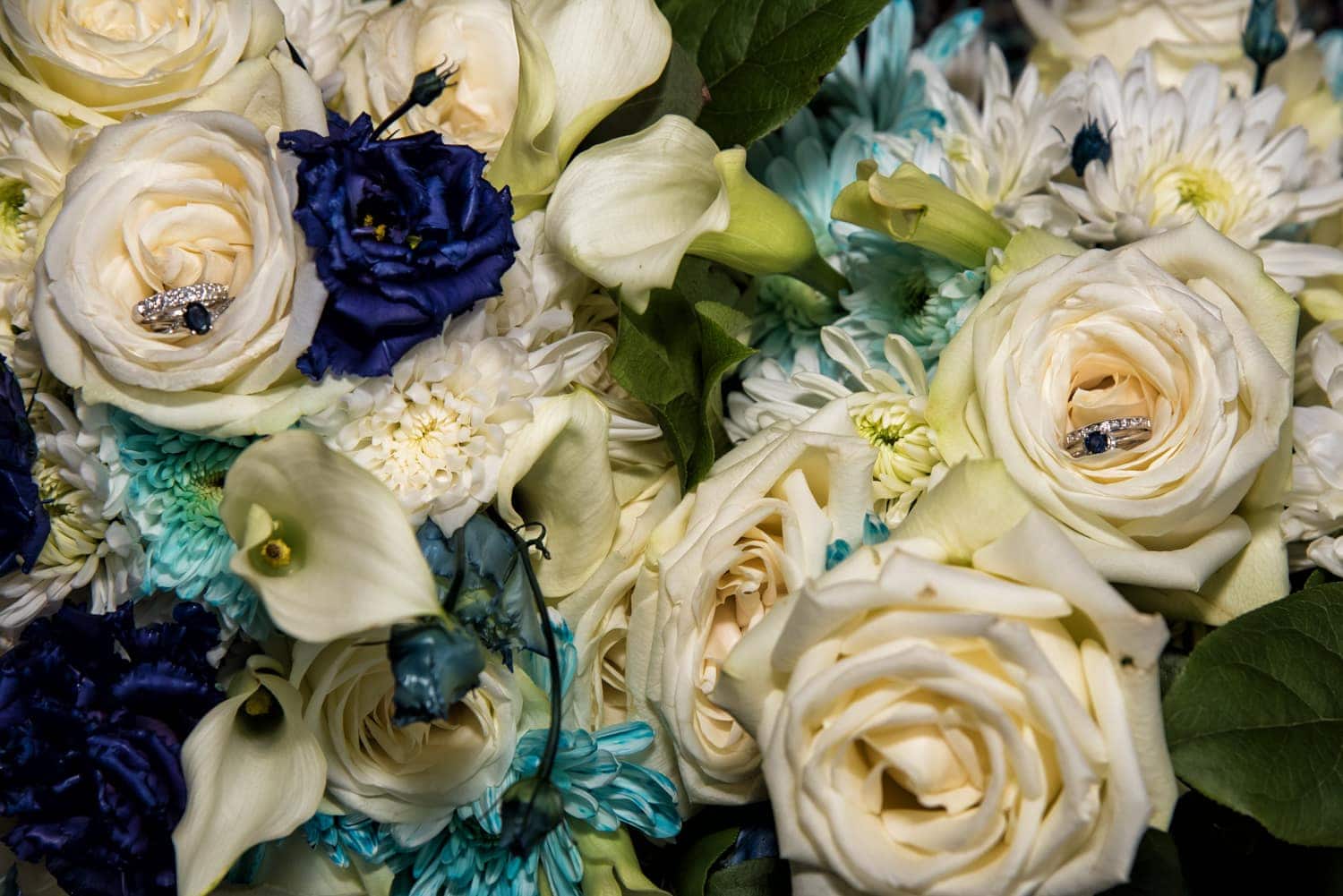 A wedding bridal bouquet of ivory and navy roses and flowers.
