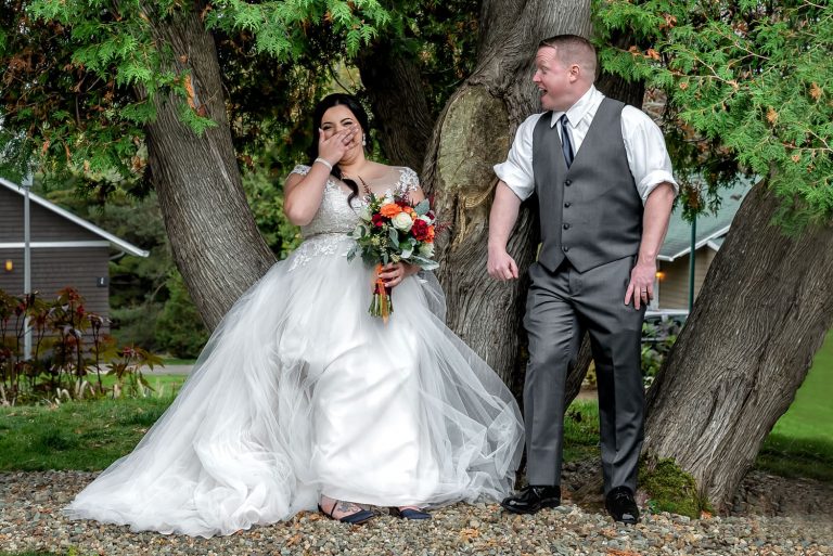 Bride and groom sharing a joyful moment outdoors in Halifax.