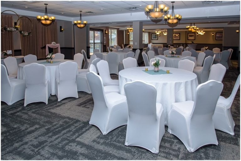 Charming Halifax wedding banquet hall with white draped chairs, floral accents, and ambient lighting for memorable events.