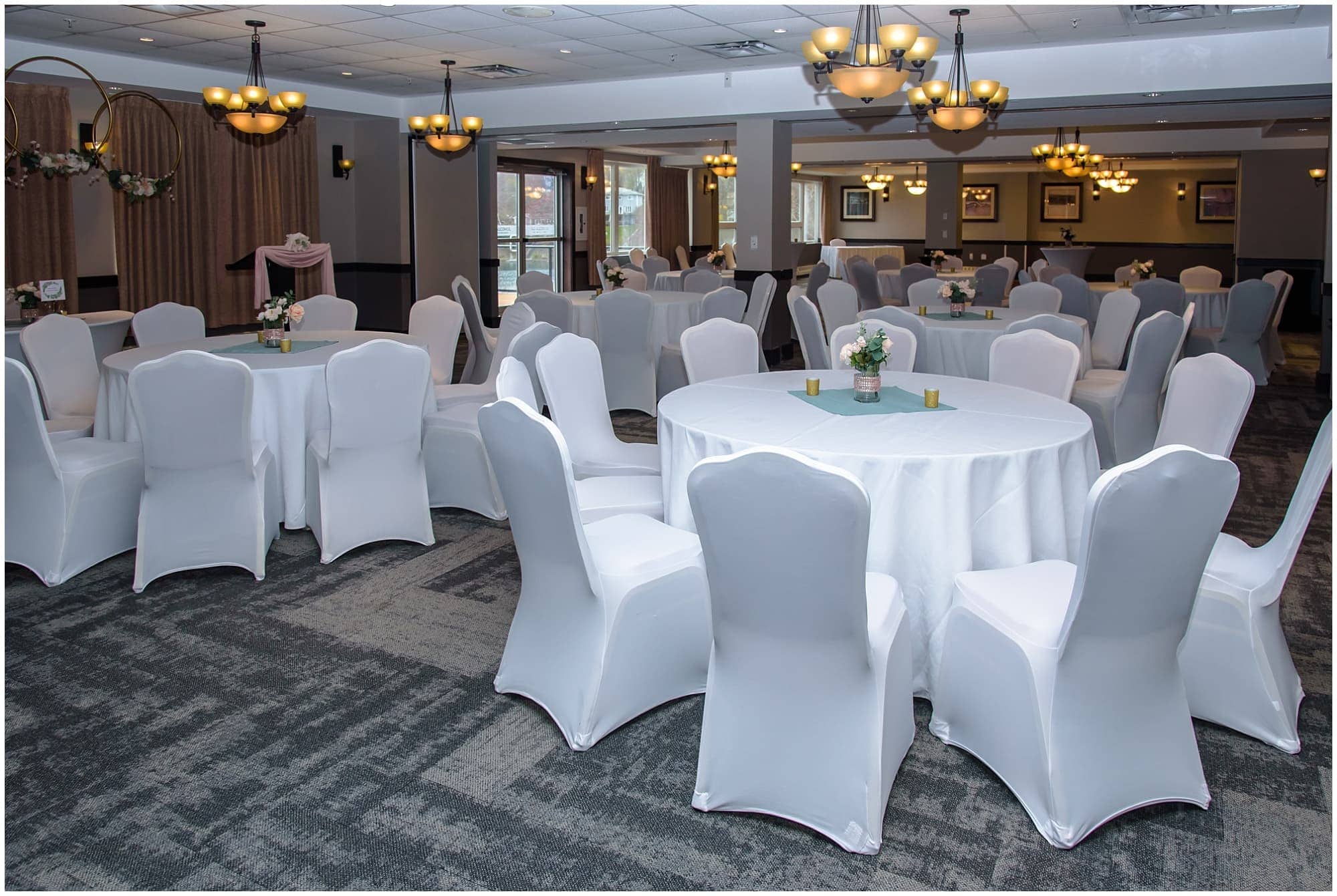 Charming Halifax wedding banquet hall with white draped chairs, floral accents, and ambient lighting for memorable events.