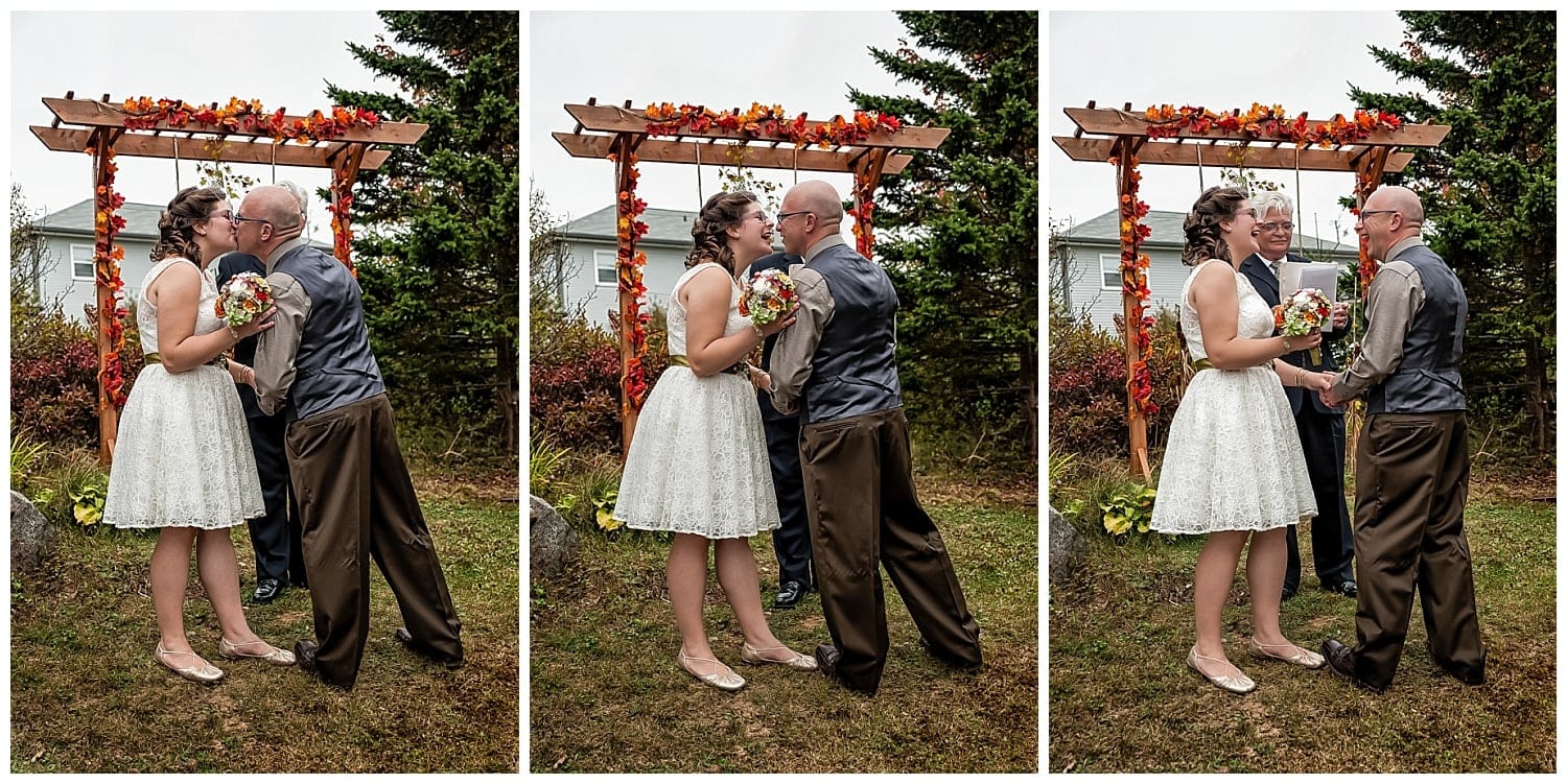 The bride and groom share their first kiss during their backyard wedding in Dartmouth, NS.