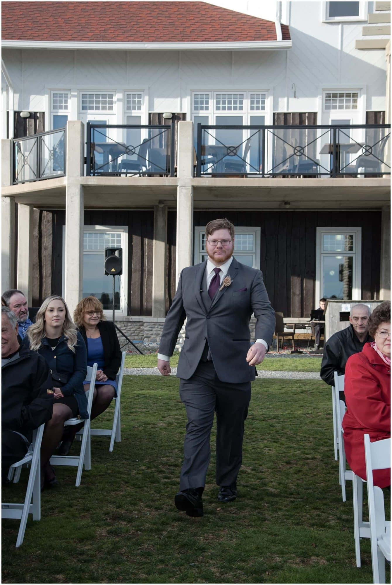 The groom walks up the aisle to the alter for his wedding ceremony at White Point Beach Resort in NS.