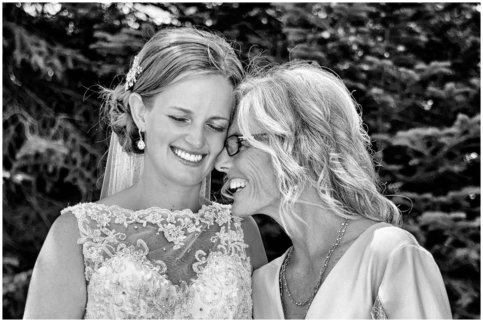 A candid moment between the bride and her mother both smiling at her parent's home in Cole Harbour.