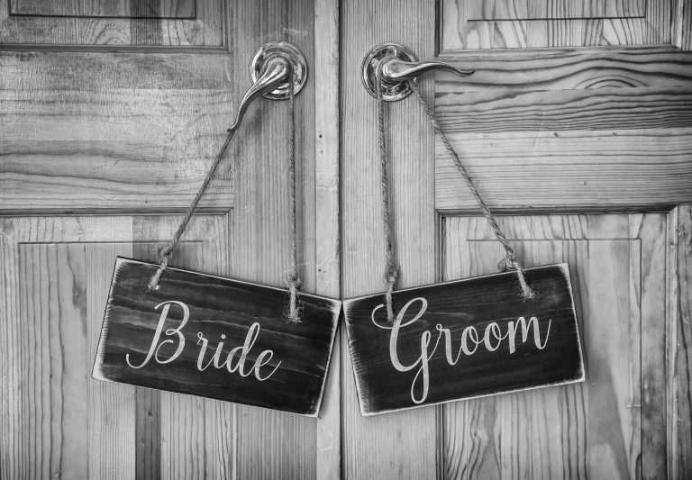 Halifax wedding photographer captures bride and groom signs on rustic wooden door.