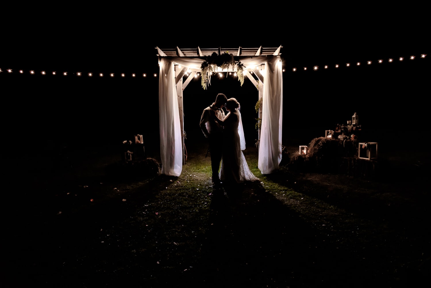 The bride and groom pose for a night silhouette portrait at their wedding at the barn at sadie belle farm.