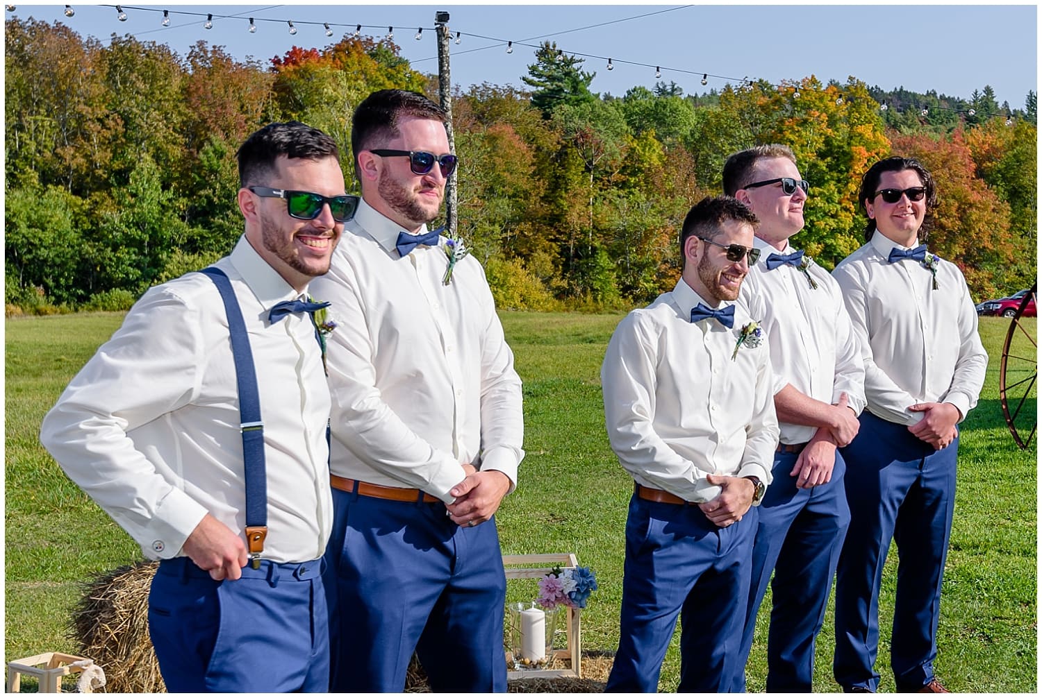 The groom stands with his groomsmen waiting for his bride to walk up the aisle during his rustic barn wedding ceremony at the Barn at Sadie Belle Farm.