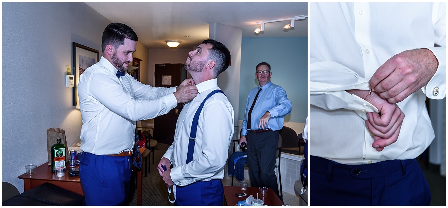 The groom getting help from a groomsmen to put his bow tie and cufflinks on during his wedding day prep at the Super 8 in Windsor NS.