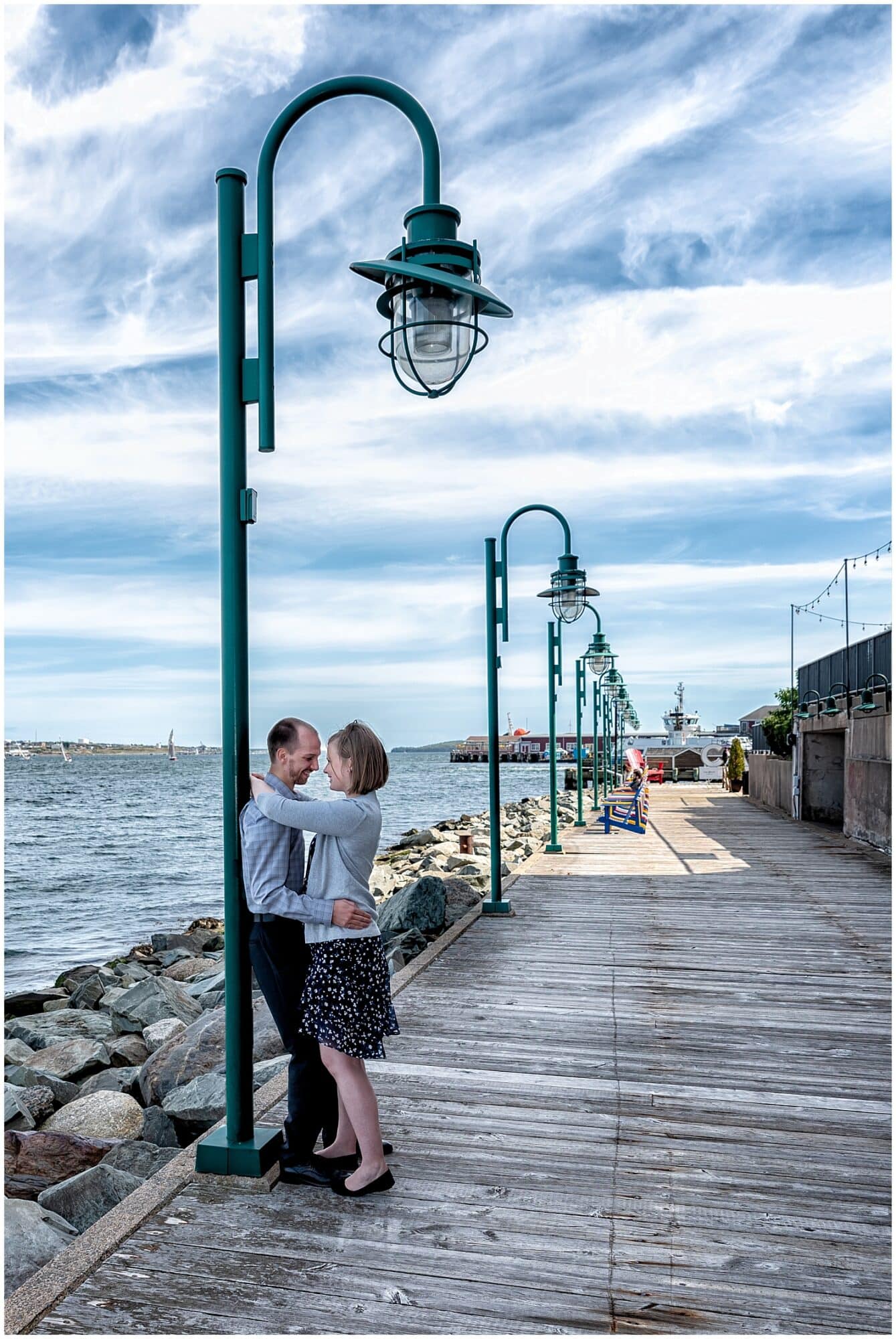 A newly engaged couple embrace and gaze at each other during their engagement photos at the Historic Properties in Halifax NS.