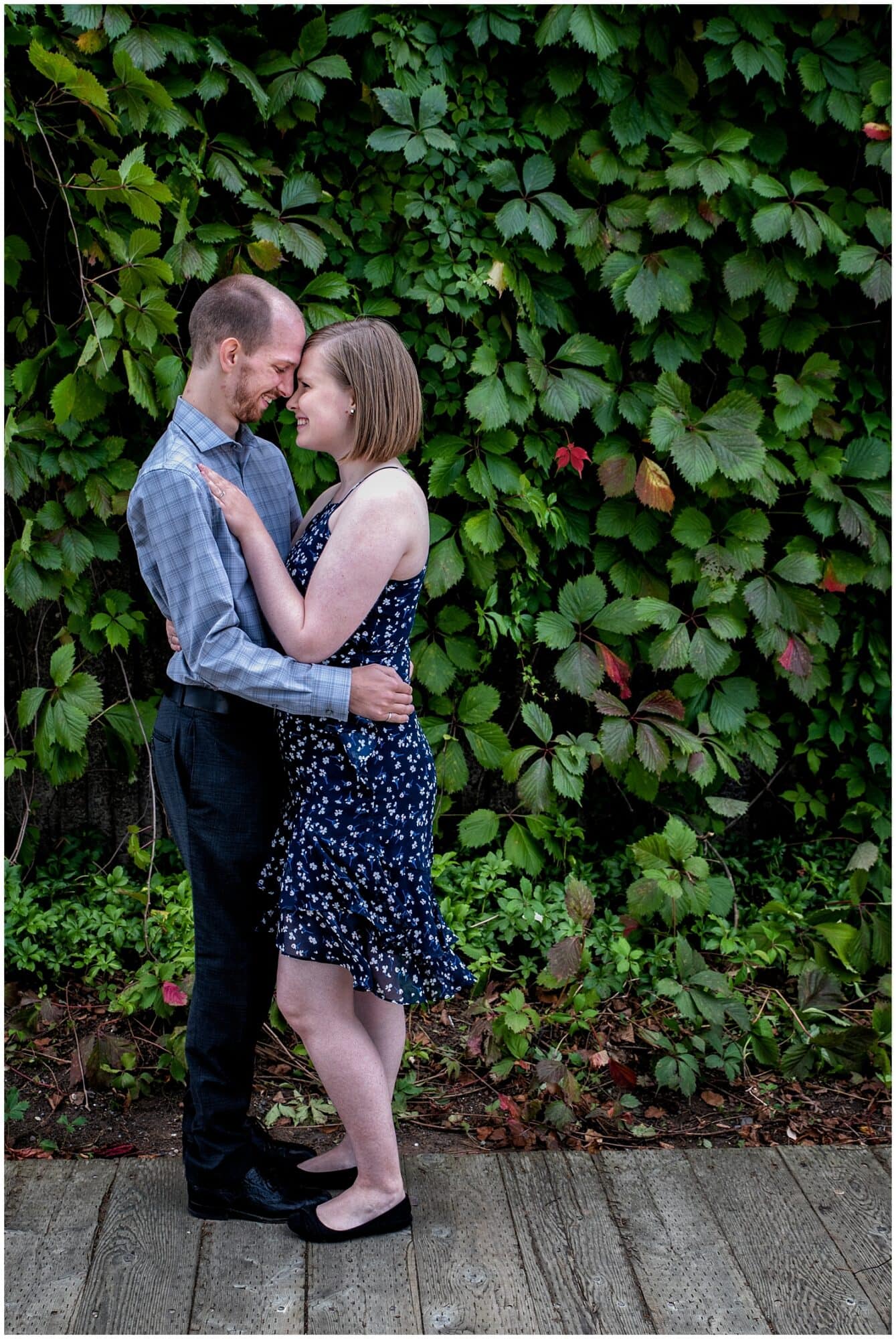 A cute couple embrace during their engagement photos at the Historic Properties in Halifax NS.