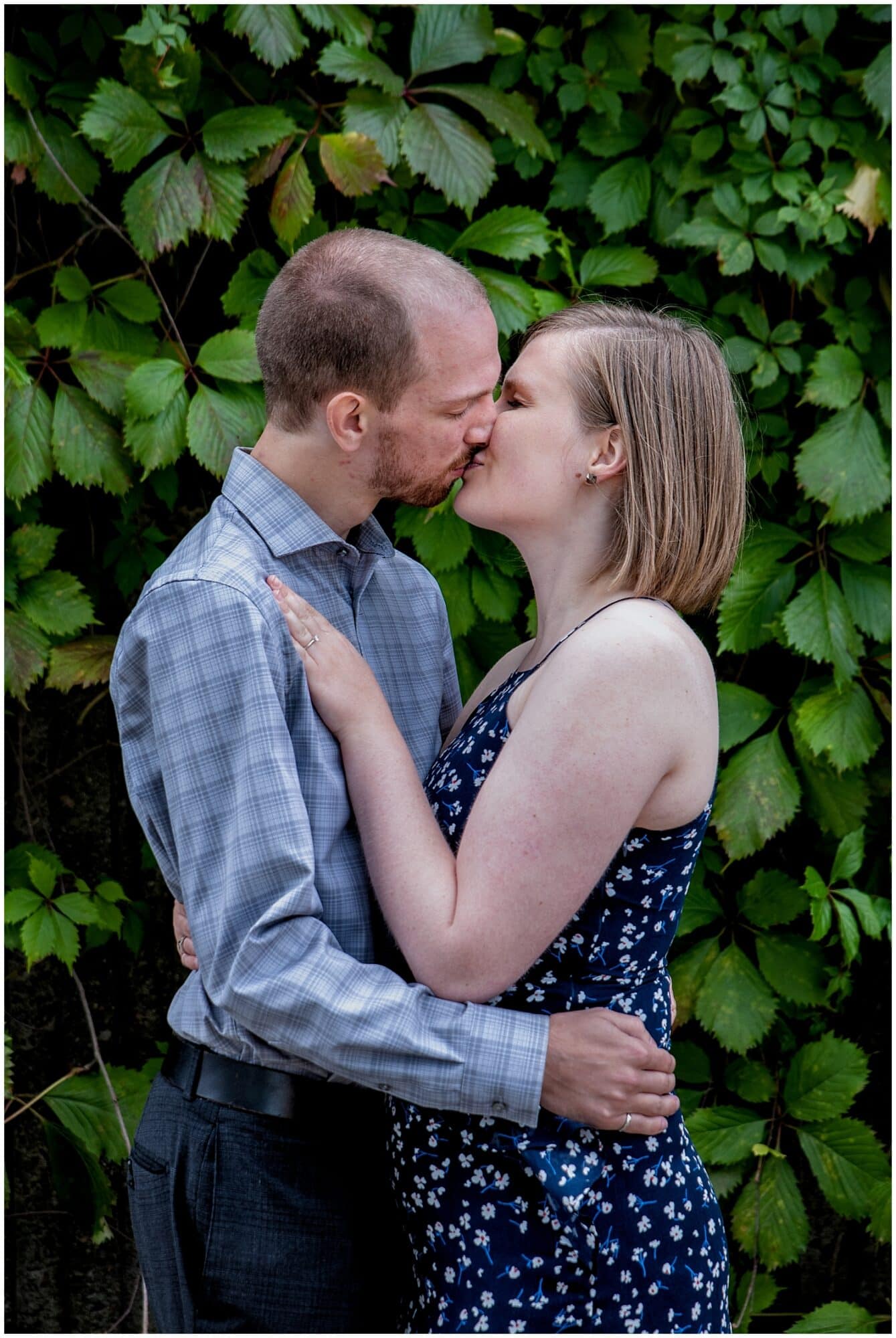 A cute couple kiss during their engagement photos in the Historic Properties in Halifax NS.