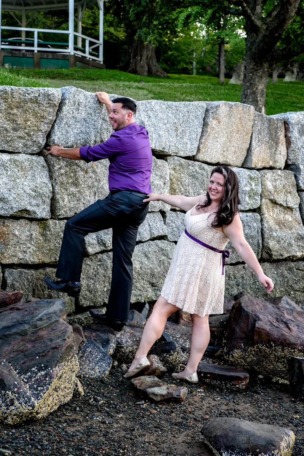 A cute couple plays around during their engagement photos at the Dingle Tower in Sir Sandford Fleming Park Halifax, NS.