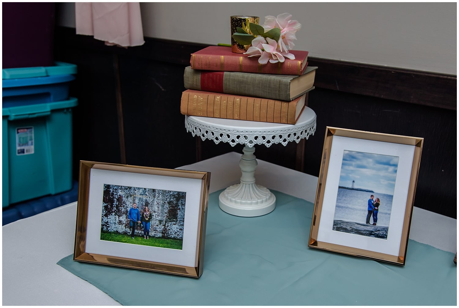 Guest book table at a wedding with engagement photos framed.