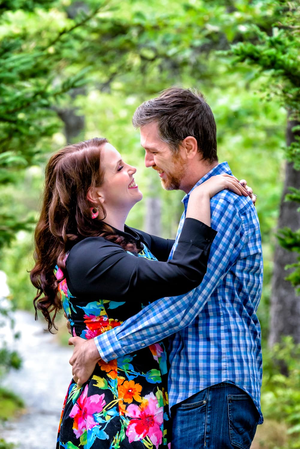 A couple in love hold and gaze at each other during their engagement photo session at Shubie Park in Dartmouth, NS.