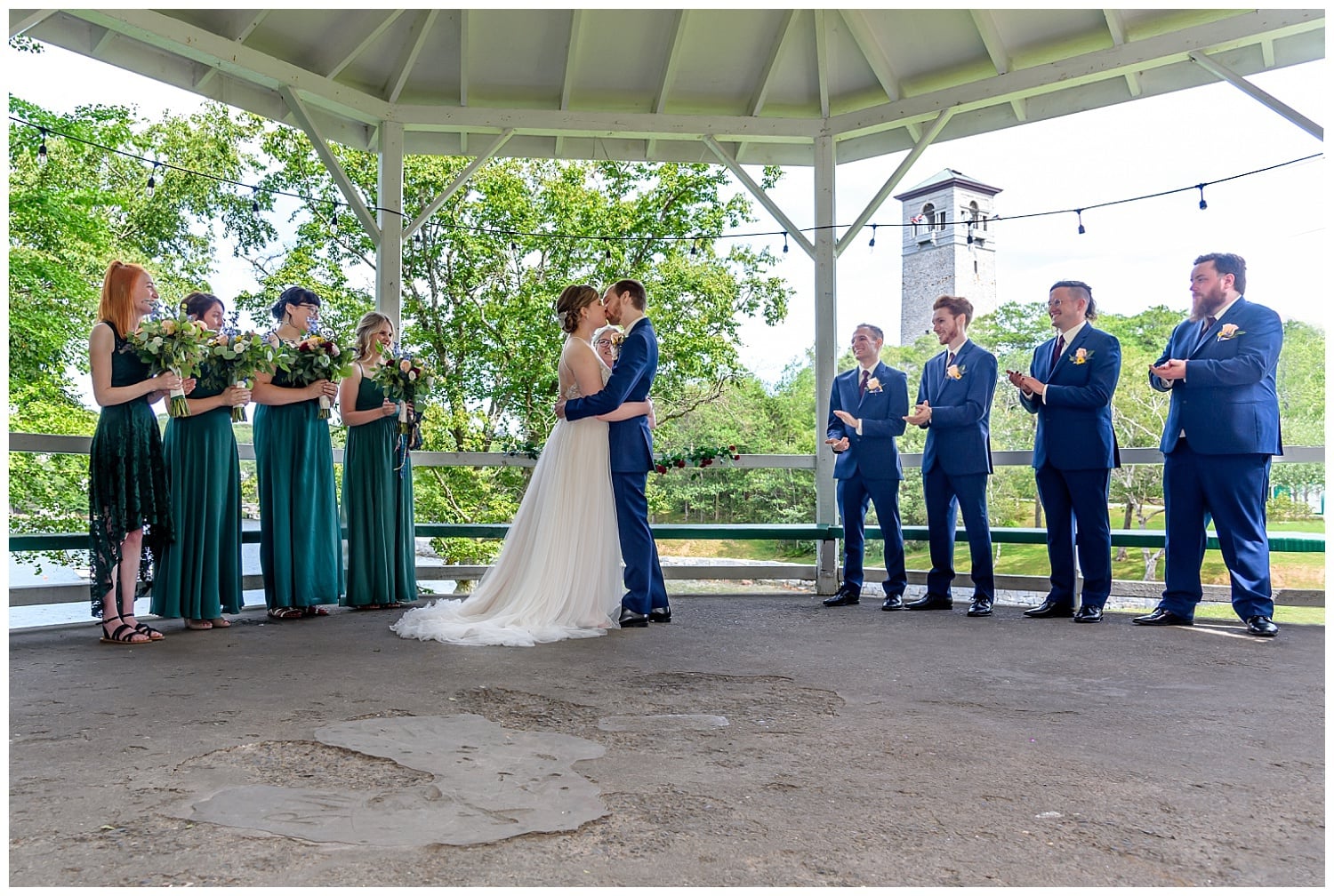 the bride and groom have their first kiss during their wedding ceremony in the gazebo at Sir Sandford Fleming Park in Halifax, NS.