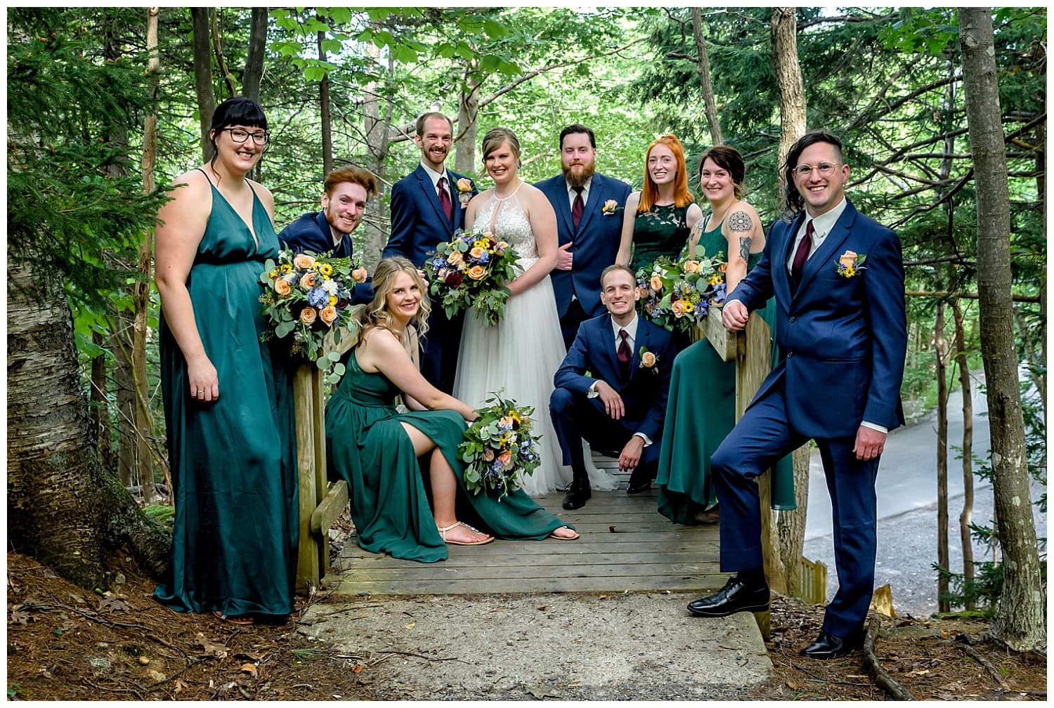The bride and groom pose with their wedding party for their wedding photos in the forest surrounding Sir Sandford Fleming Park in Halifax, NS.