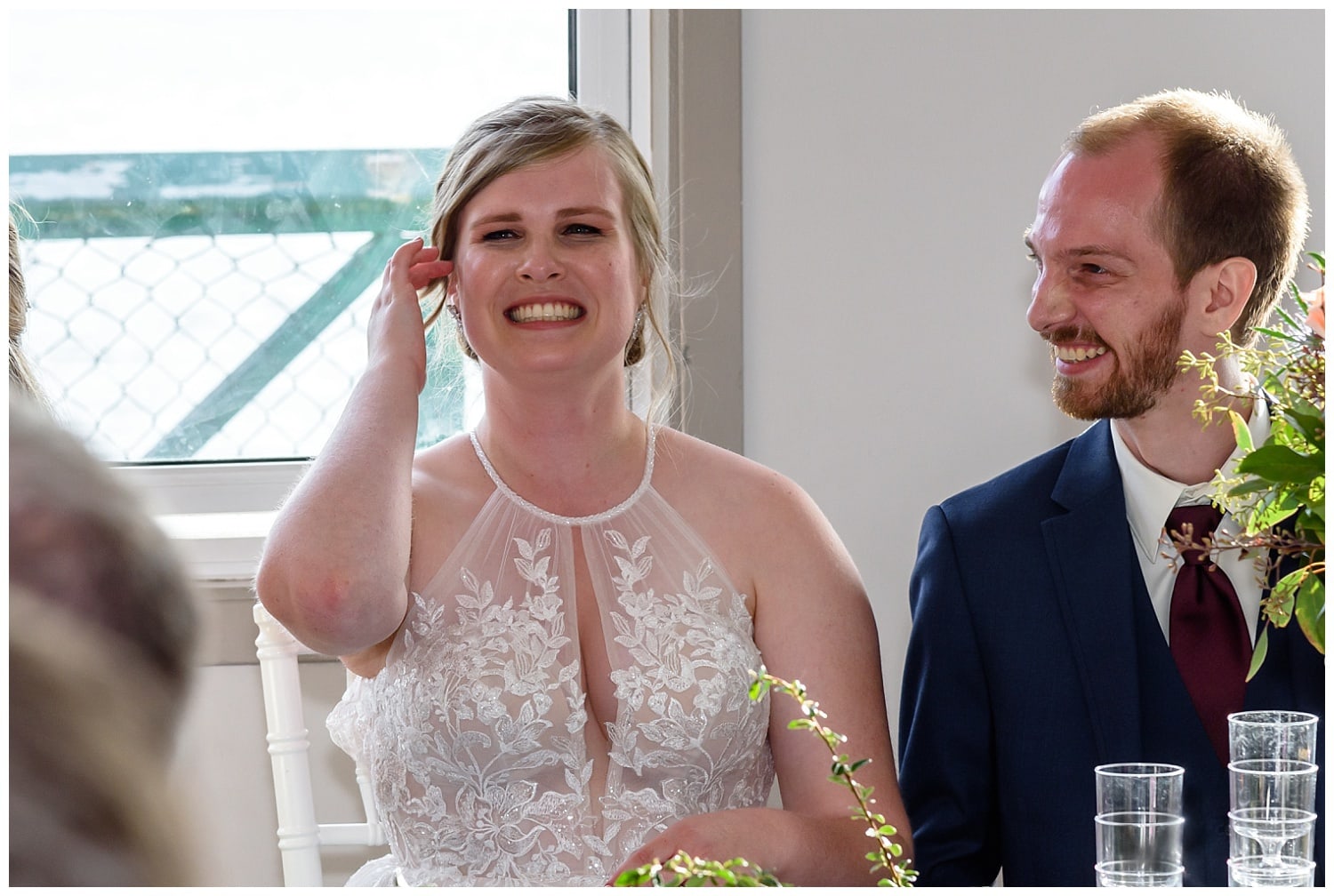 The bride is captured smiling largely during her wedding reception at the St Mary's Boat Club in Halifax NS.