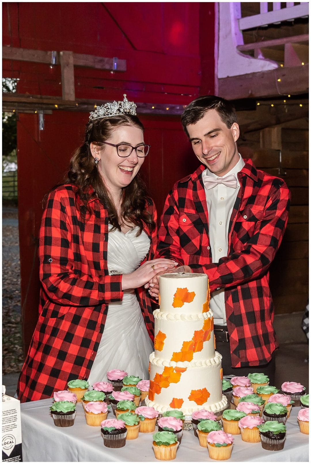 The bride and groom cut their cake together at their wedding reception in the Kinley Farm in Lunenburg, NS.