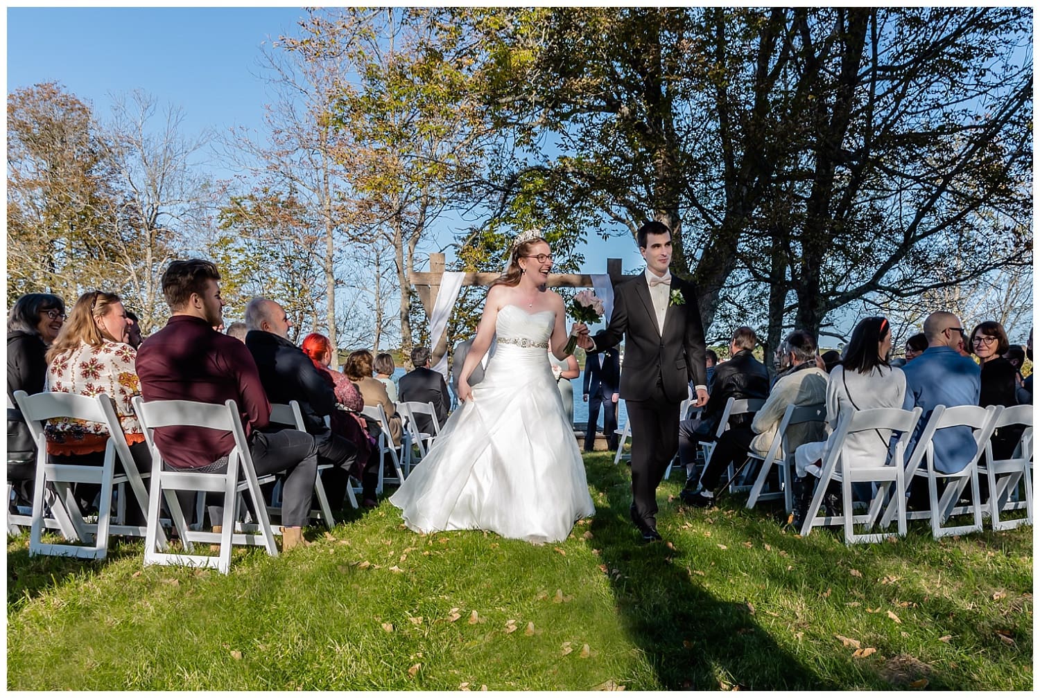 The bride and groom walk down the aisle after their wedding ceremony at the Kinley Farm in Lunenburg, NS.