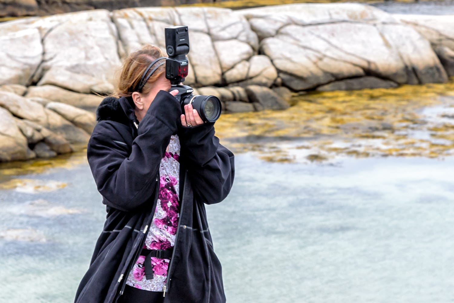 Sandra Adamson photographing wedding photos at Peggy's Cove in Nova Scotia.