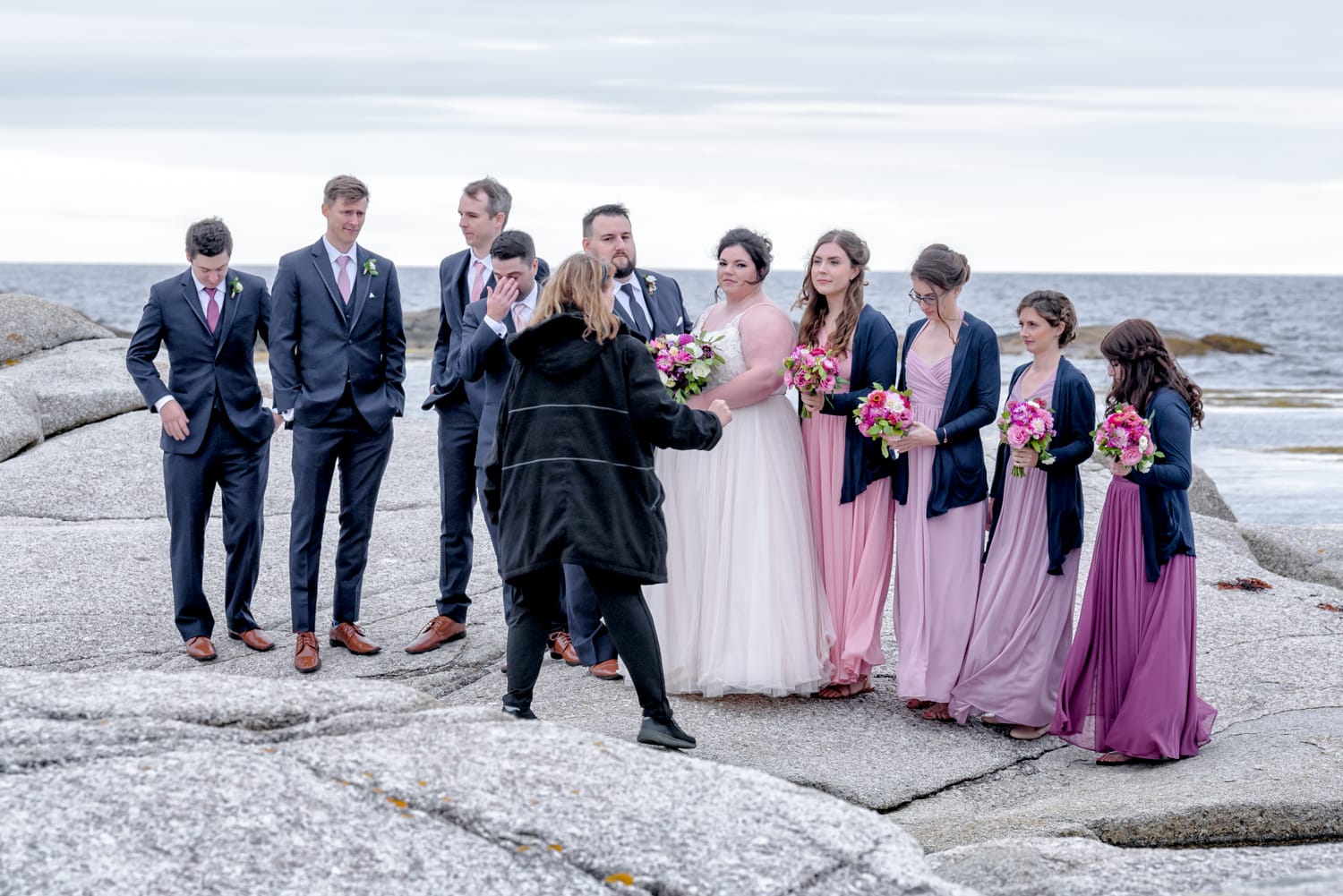 Sandra Adamson at work photographing the wedding party at Peggy's Cove in NS.