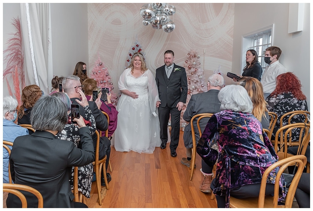 The bride and groom walk down the aisle after their wedding ceremony at the Wolfville Chapel in Nova Scotia.
