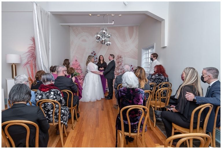 A wedding ceremony with the bride and groom at the Wolfville Chapel in Nova Scotia.