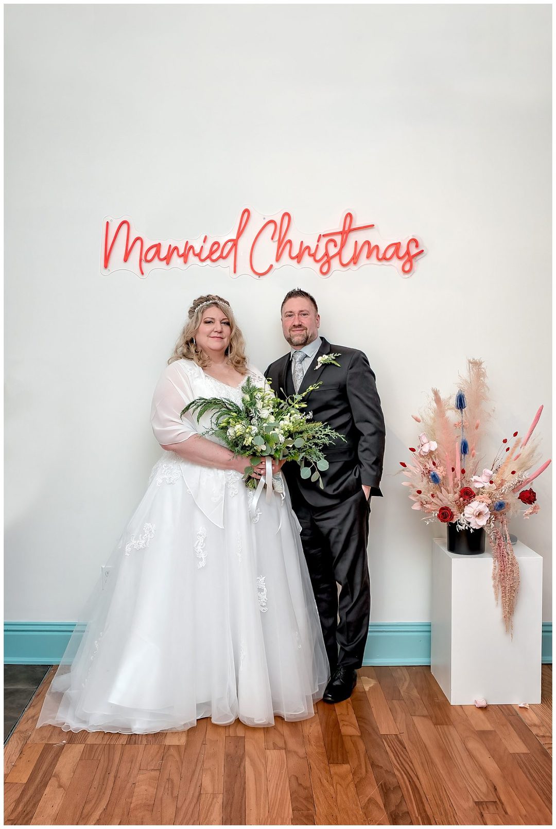 A christmas wedding with the bride and groom at the Wolfville Chapel in Nova Scotia.