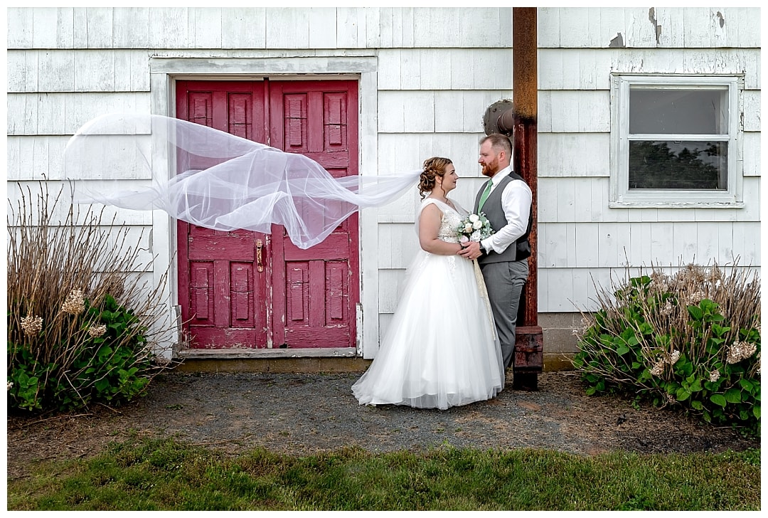 The bride and groom pose for wedding photos at Healy Farm in Kentville NS.