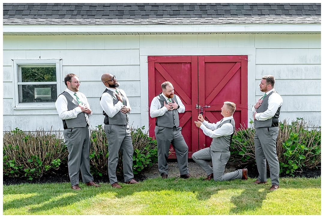 Groom with his groomsmen posing for fun wedding photos at Healy Farm in NS.