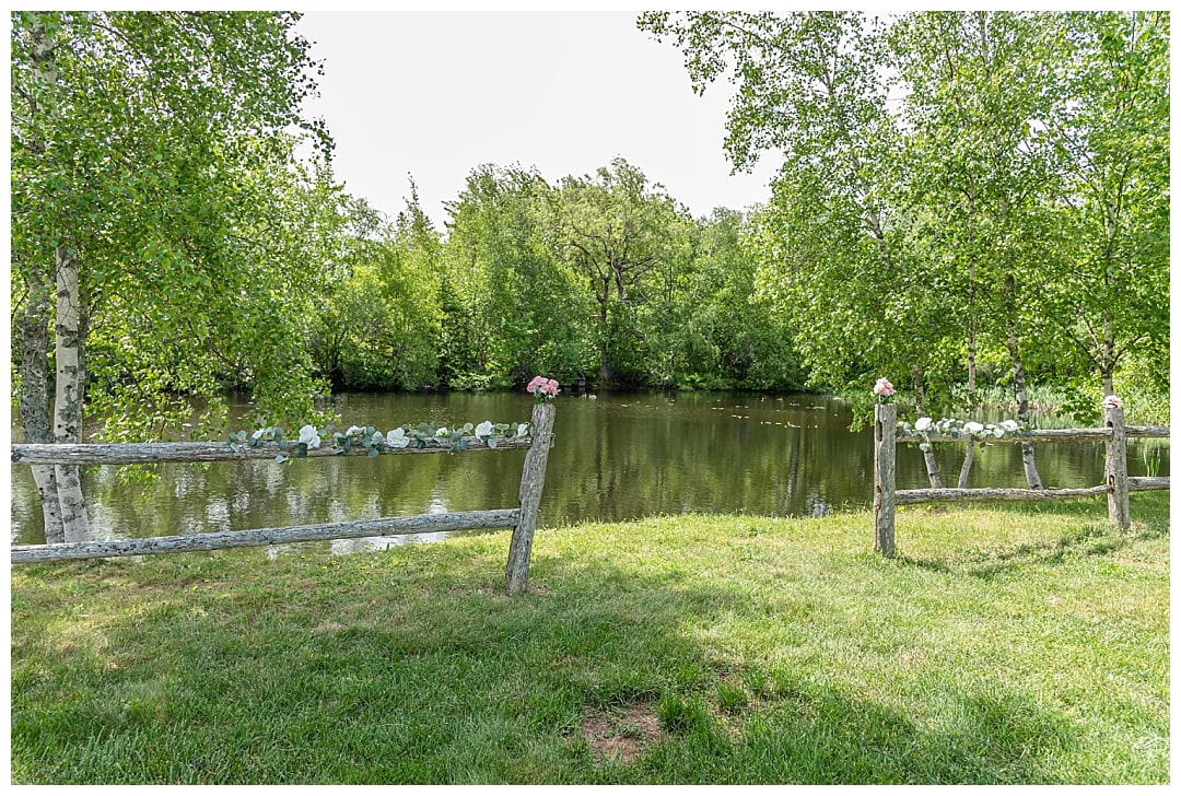 The wooden accent fence along the side of the river where the wedding ceremony takes place at Healy Farm.