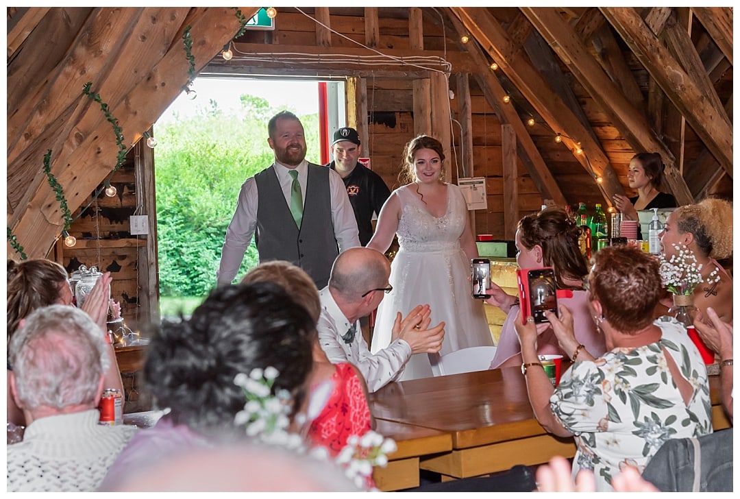 The bride and groom make their entrance into the barn at Healy Farm for their wedding reception in NS.