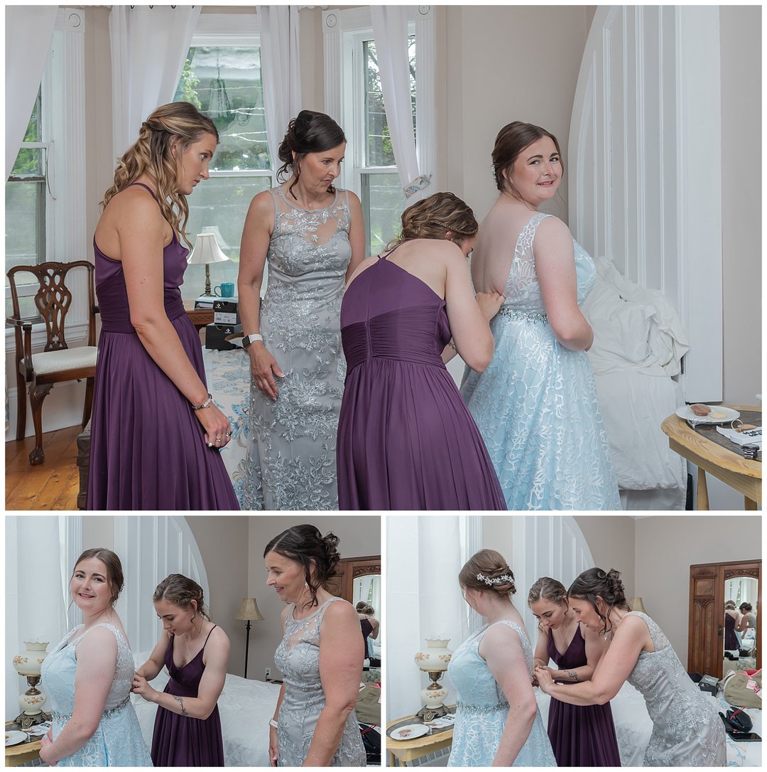 The bride being helped into her wedding gown by her bridesmaids during bridal prep at the Carlisle House in Annapolis Royal.