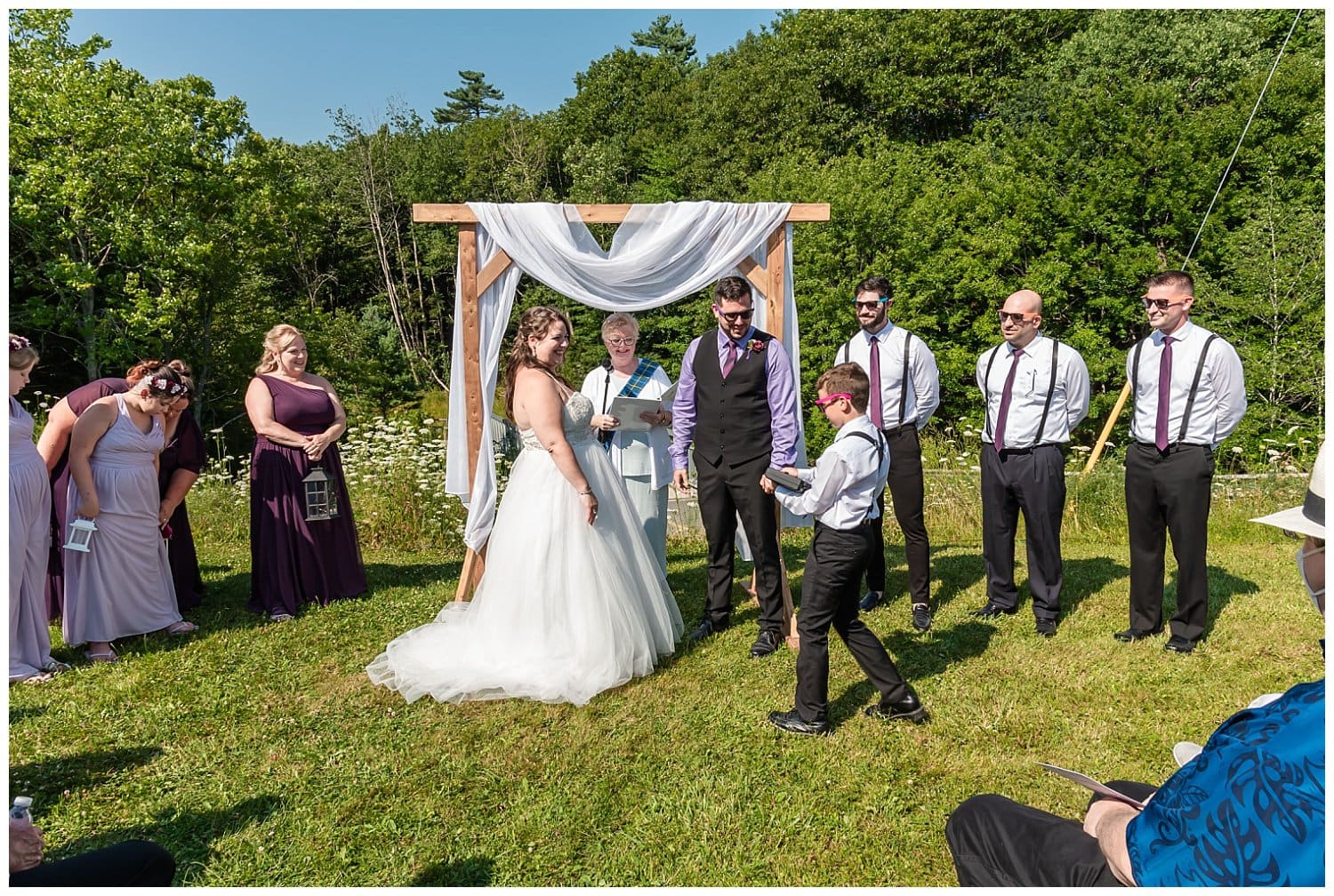 The ring bearer brings the rings to the officiant of the wedding ceremony.