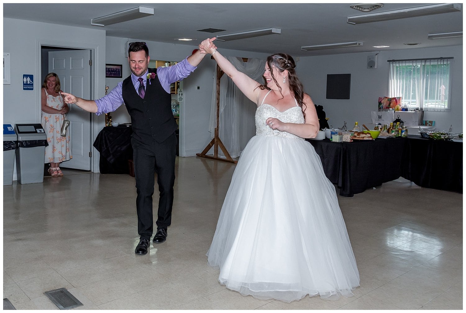 The bride and groom make their grand entrance into the reception.