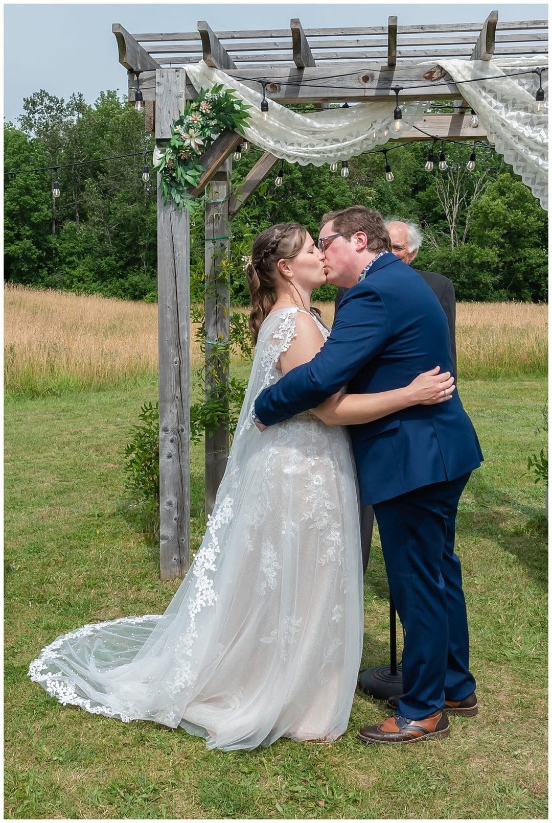 The bride and groom have their first kiss during their wedding ceremony at the Barn at Sadie Belle Farm.