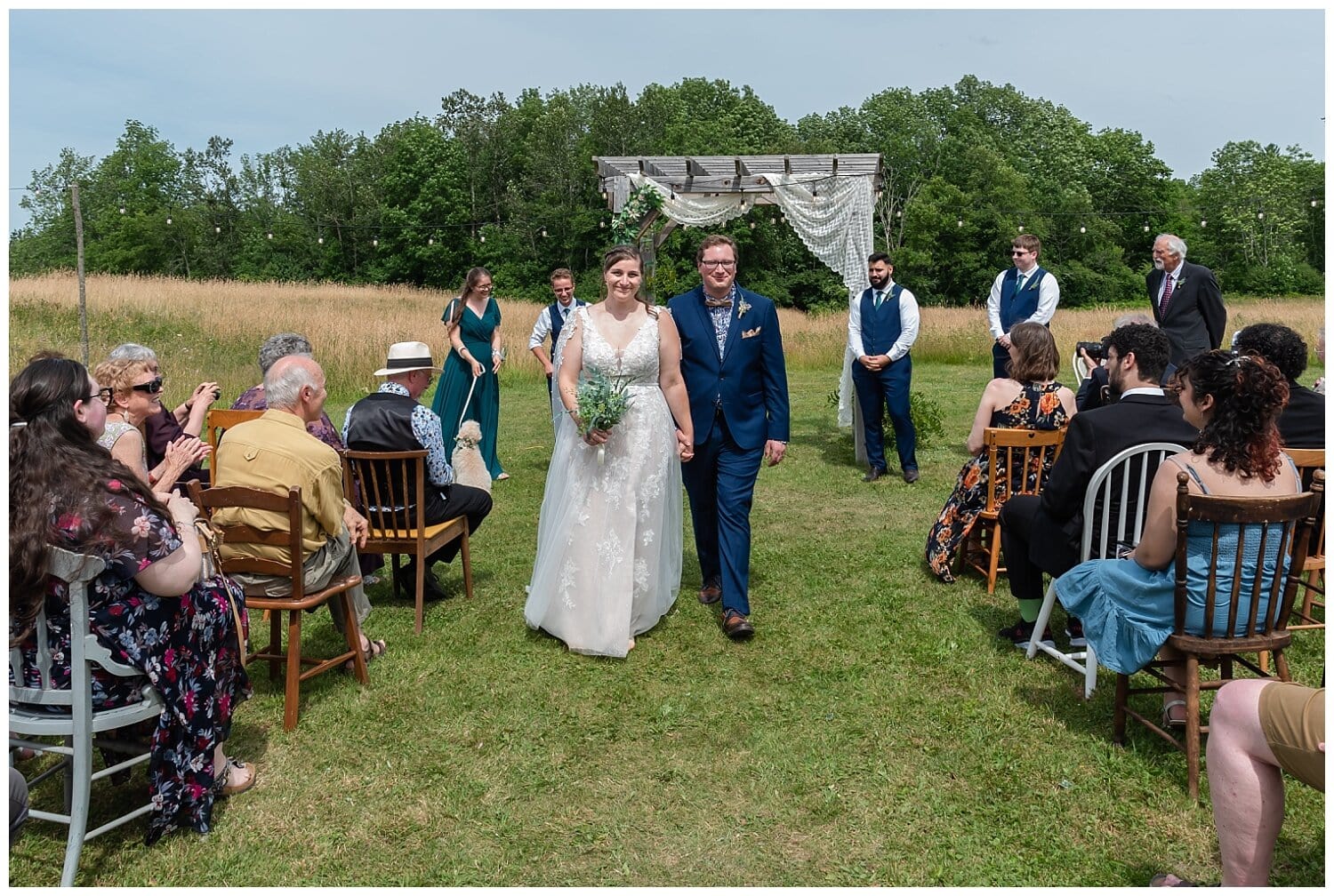 The bride and groom smile as they walk down the aisle after their wedding ceremony finished.