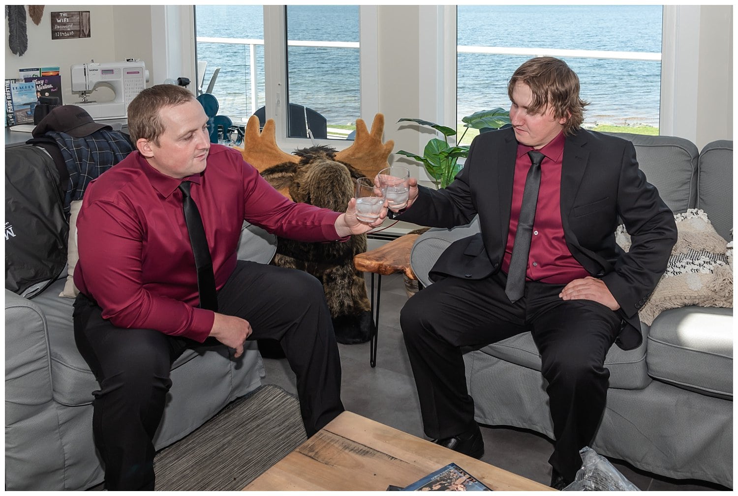The groom and best man share a drink together before the wedding ceremony.