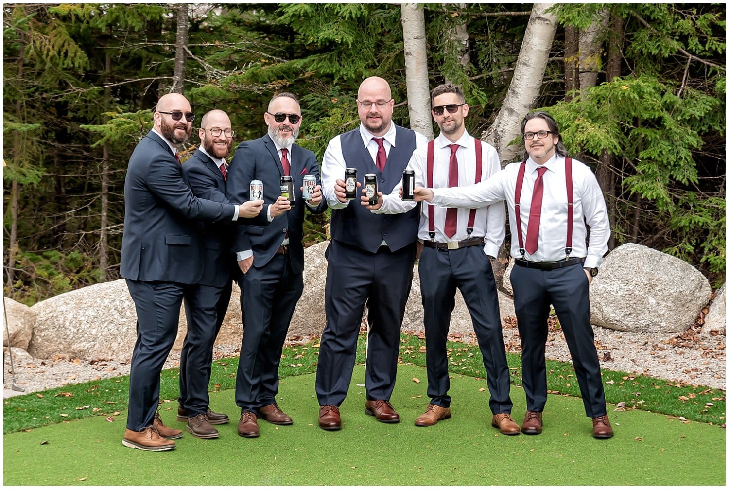The groom and groomsmen with beer in hand while getting ready for the wedding.
