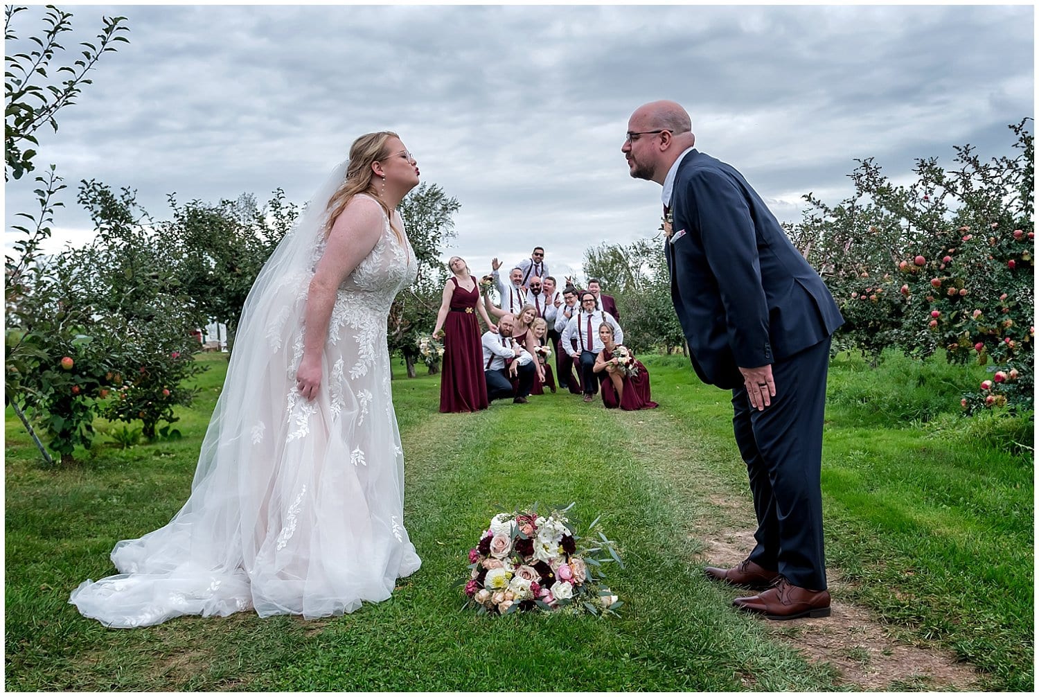 The bride, groom and wedding party pose for fun wedding photos at the Bent Ridge Winery in NS.